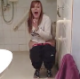 The bathroom door is barged open to reveal a British girl who admits to taking a poo. The cameraman complains about the smell. No audible pooping or poop shown.
